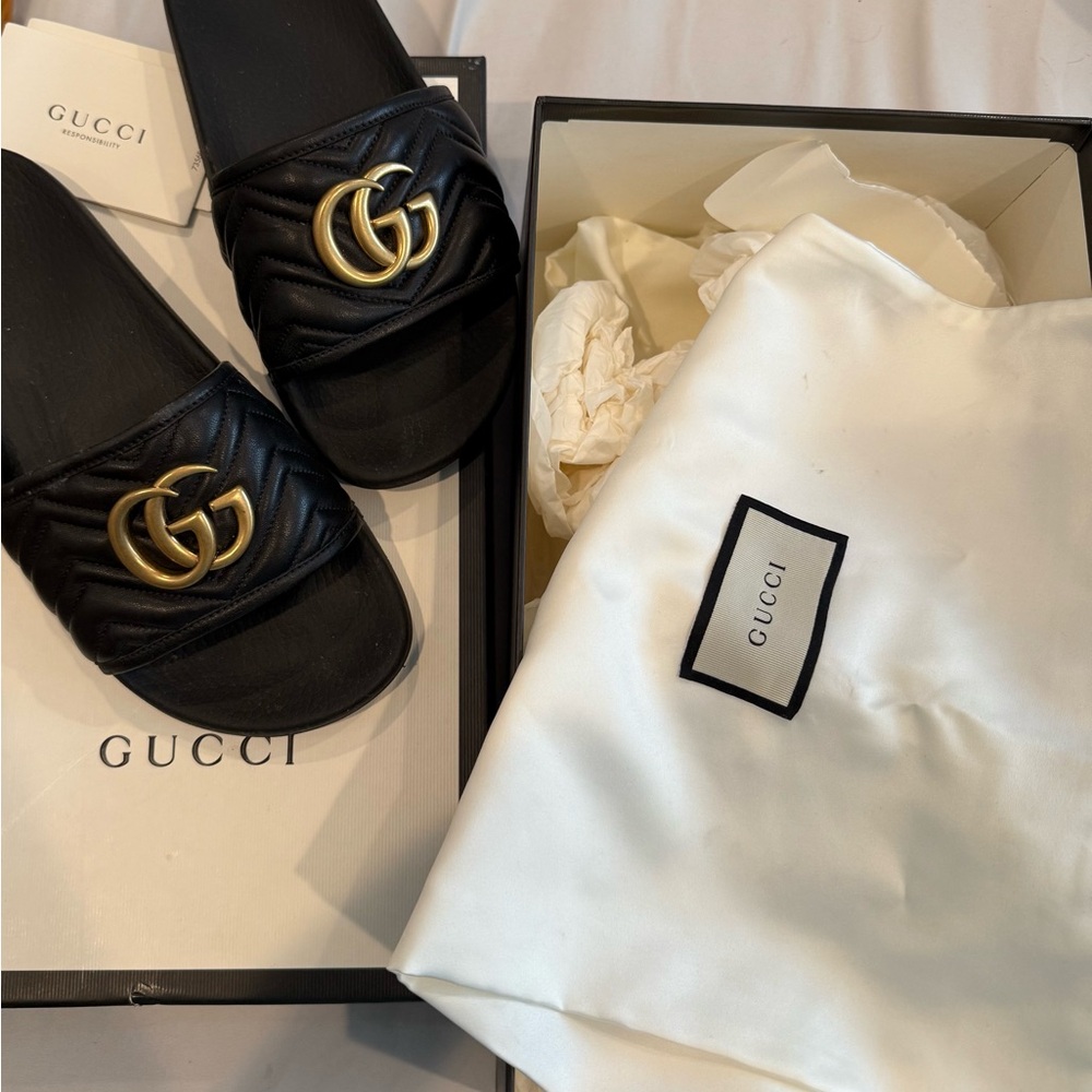 Gucci Black Slides with Gold Emblem